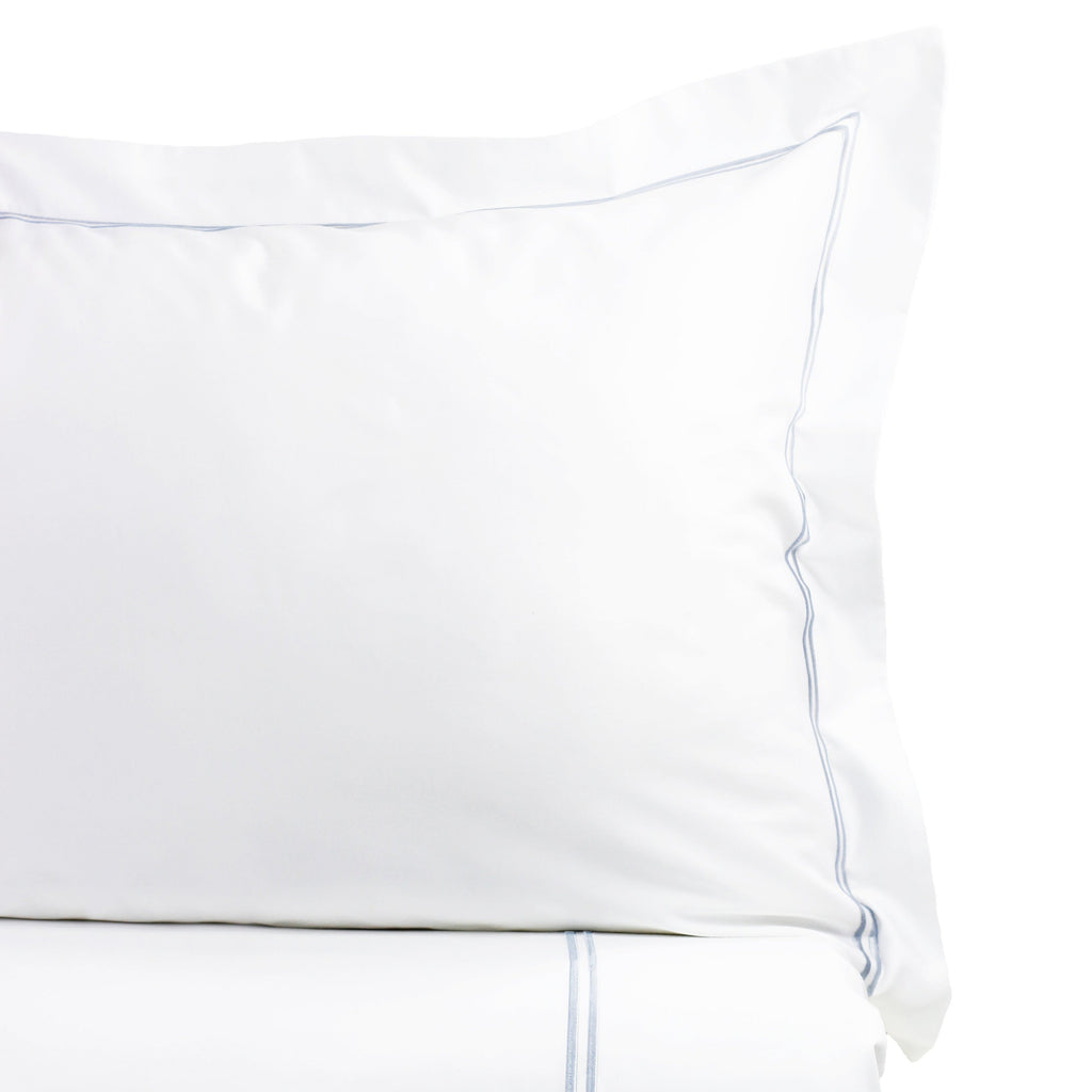 White pillowcase with blue piping on a white background - The Well Appointed House