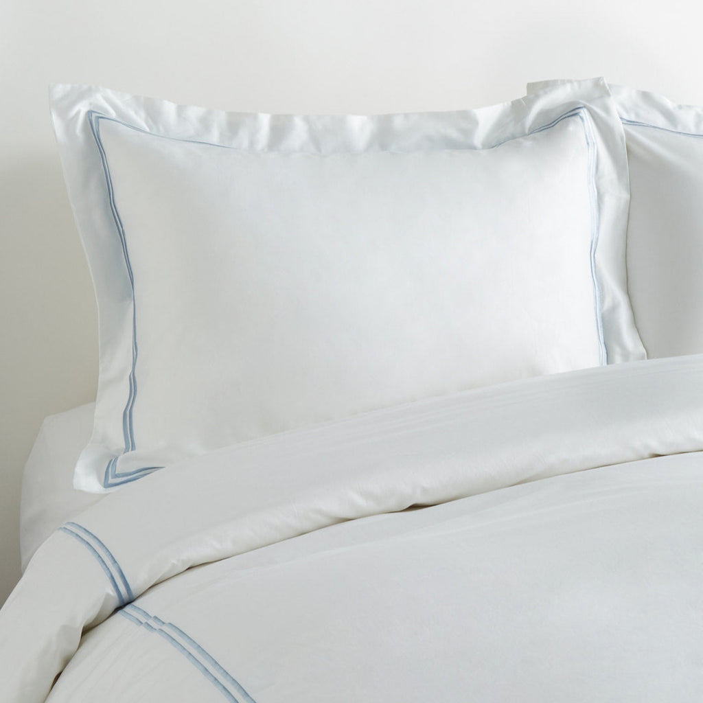 White satin pillowcases with blue piping on a white background - The Well Appointed House